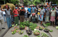 Indian farmers take vegetables in a rally at the Trinamool Congress Student cell during a protest against farm bills in Kolkata. (Photo by Dipa Chakraborty/Pacific Press/LightRocket via Getty Images)