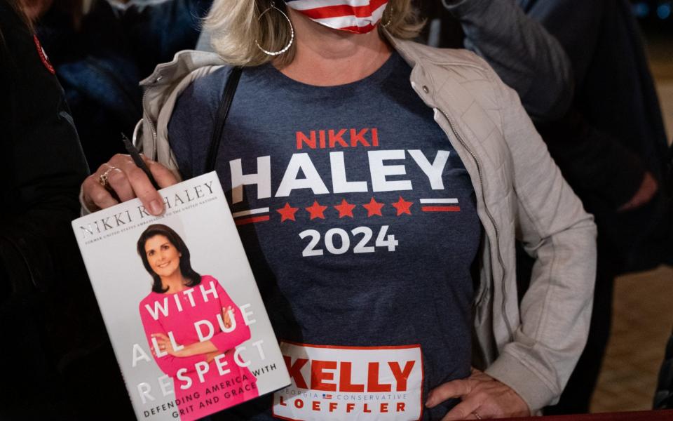 An woman wearing a 'Nikki Haley 2024' t-shirt waits to get a book signed by Nikki Haley, former ambassador to the United Nations - Elijah Nouvelage /Bloomberg