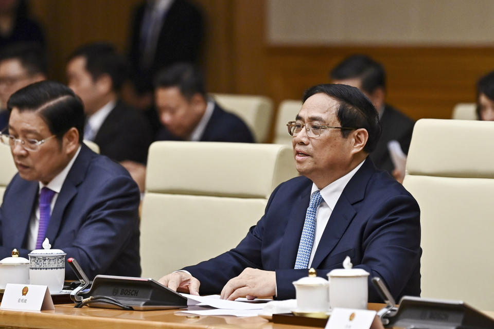 Vietnam's Prime Minister Pham Minh Chinh, right, speaks during a meeting with China's President Xi Jinping at the government office in Hanoi, Vietnam, Wednesday, Dec. 13, 2023. (Nhac Nguyen/Pool Photo via AP)