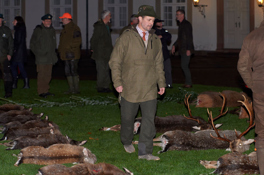 A photo of Crown Prince Frederik inspecting the slain deer.