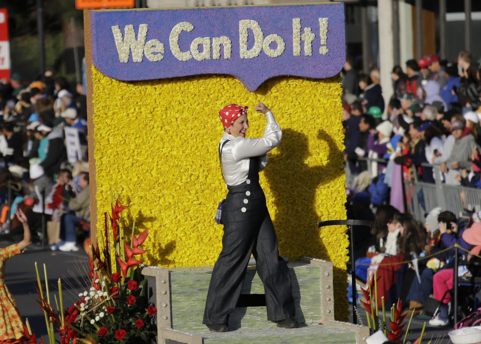 A Rosie The Riveter figure is seen aboard the Wells Fargo float in the 125th Rose Parade in Pasadena, Calif., Wednesday, Jan. 1, 2014. (AP Photo/Reed Saxon)