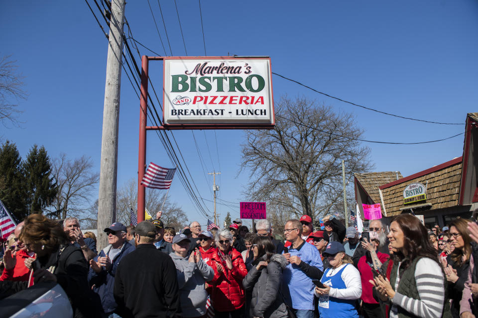 Hundreds of people gather in front of on Marlena's Bistro in Holland in support of the owner Marlena Pavlos-Hackney on Saturday March 20, 2021. (Nicole Hester/Mlive.com/Ann Arbor News via AP)