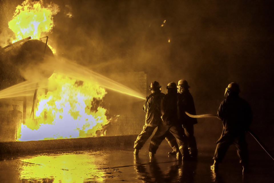 Firefighters hosing down a fire