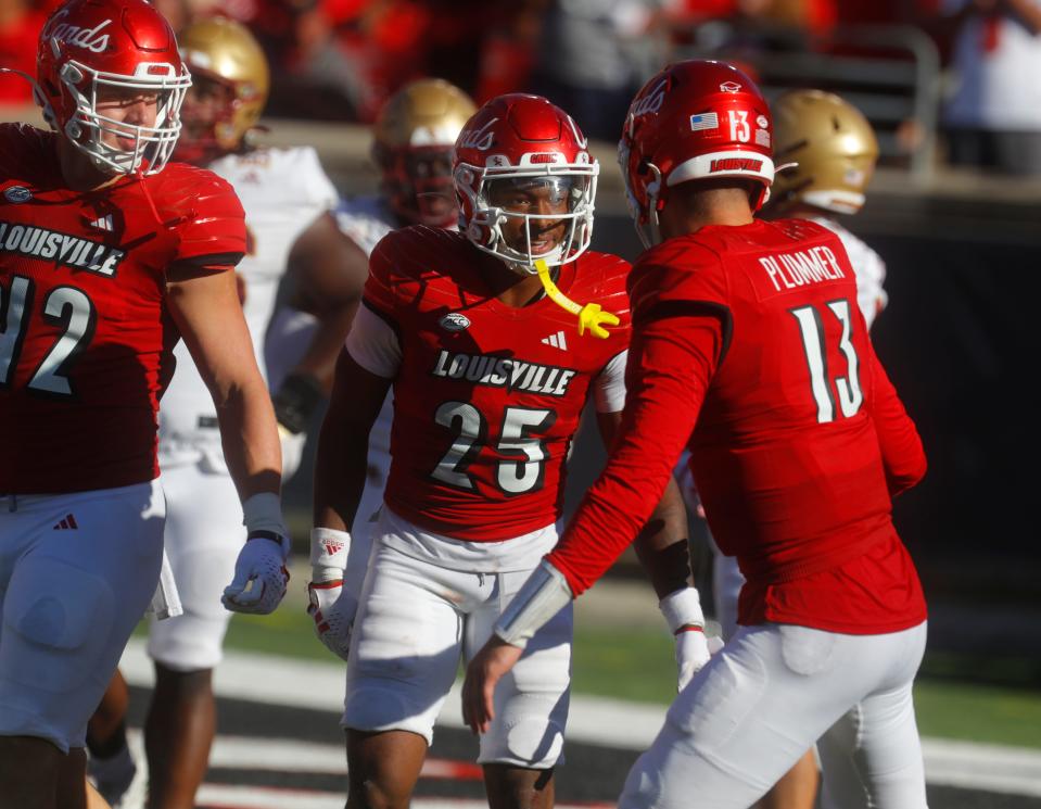 Louisville’s Jawhar Jordan celebrates running for a touchdown with teammate Jack Plummer against Boston College Saturday afternoon at L&N Stadium. Sept. 23, 2023