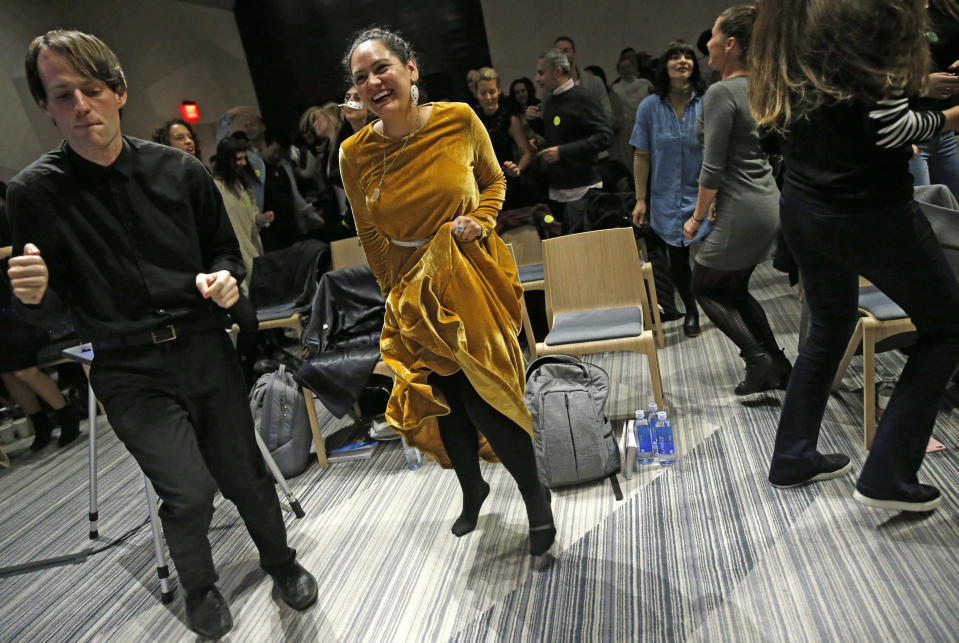 In this March 8, 2017 photo, Andrew Hoepfner, left, and Pamela Martinez, center, dances along with participants at a sober social event sponsored by The Shine at a hotel in the Williamsburg neighborhood of the Brooklyn borough of New York. Alcohol-free events, which are popping up in New York, Los Angeles and Chicago, are part of a trend fueled by millennials seeking to find meaningful connections while they party. (AP Photo/Kathy Willens)