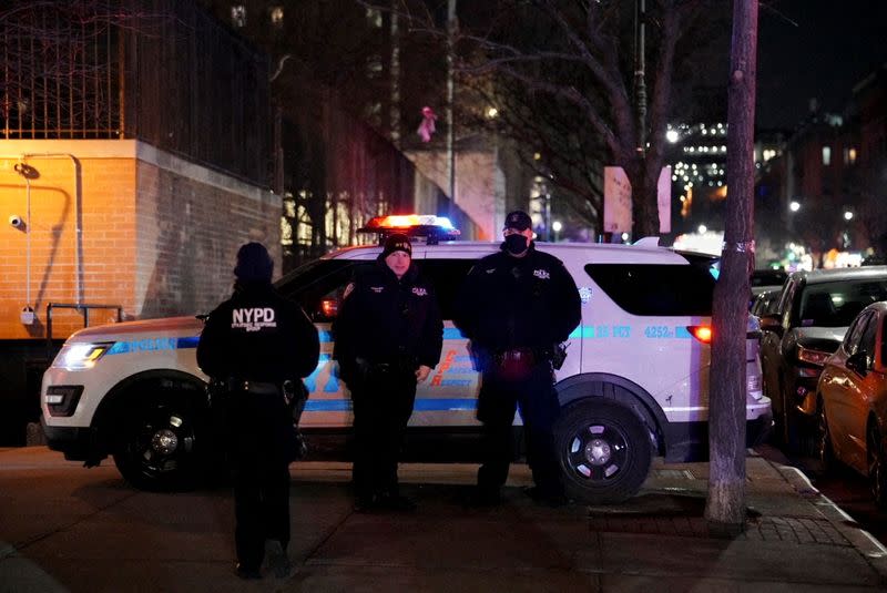 Emergency personnel respond at the scene where NYPD officers were shot while responding to a domestic violence call