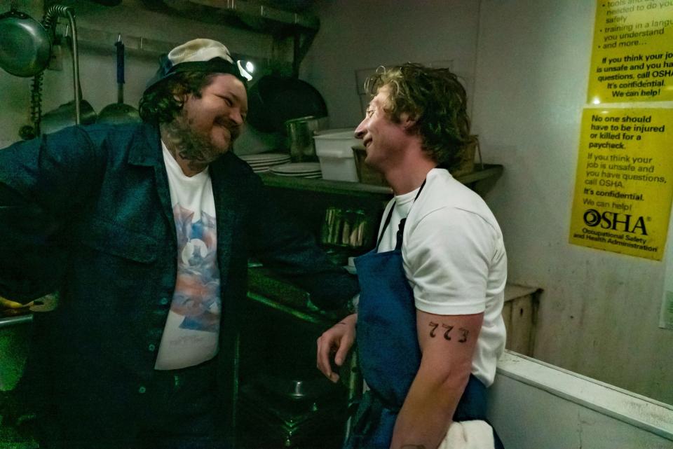 Carmy and Neil in the kitchen, the 773 tattoo showing on his arm