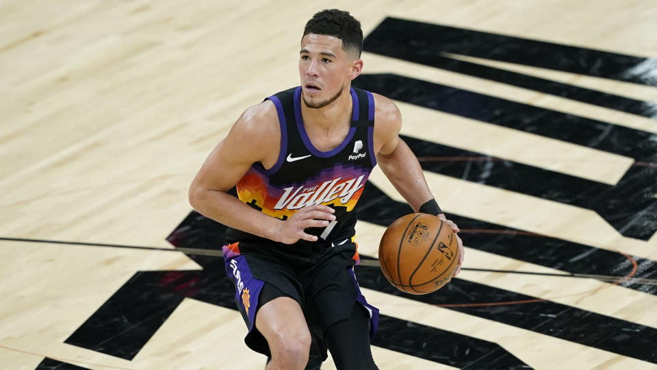 Phoenix Suns guard Devin Booker (1) against the Philadelphia 76ers during the second half of an NBA basketball game, Saturday, Feb. 13, 2021, in Phoenix.(AP Photo/Matt York)