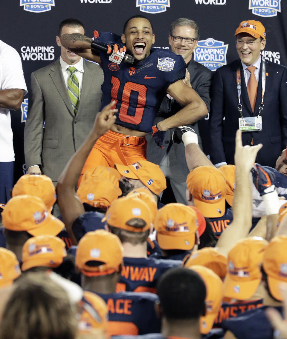 Syracuse wide receiver Sean Riley (10) leads the team in a cheer after defeating West Virginia in the Camping World Bowl NCAA college football game Friday, Dec. 28, 2018, in Orlando, Fla. (AP Photo/John Raoux)