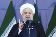 ADDS THAT ATTACK WAS ON A DIFFERENT MILITARY PARADE IN THE SOUTHWESTERN CITY OF AHVAZ - Iran's President Hassan Rouhani speaks at a military parade marking the 38th anniversary of Iraq's 1980 invasion of Iran, in front of the shrine of the late revolutionary founder, Ayatollah Khomeini, outside Tehran, Iran, Saturday, Sept. 22, 2018. Elsewhere gunmen disguised as soldiers attacked the annual parade in the southwestern city of Ahvaz, killing dozens of people and wounding others in the bloodiest assault to strike the country in recent years. (AP Photo/Ebrahim Noroozi)