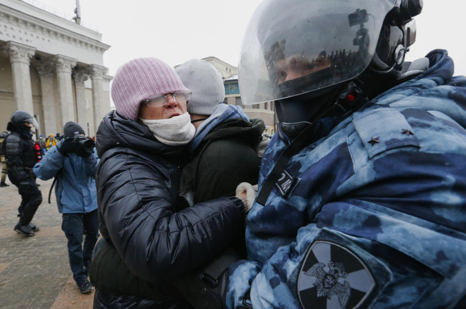 Police officer detains a woman during a protest against the jailing of opposition leader Alexei Navalny in Moscow, Russia, on Sunday, Jan. 31, 2021. Thousands of people took to the streets Sunday across Russia to demand the release of jailed opposition leader Alexei Navalny, keeping up the wave of nationwide protests that have rattled the Kremlin. Hundreds were detained by police. (AP Photo/Alexander Zemlianichenko)