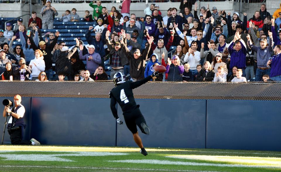 Holy Cross cornerback Devin Haskins runs in a blocked punt for a touchdown to the delight of fans Saturday at Polar Park.