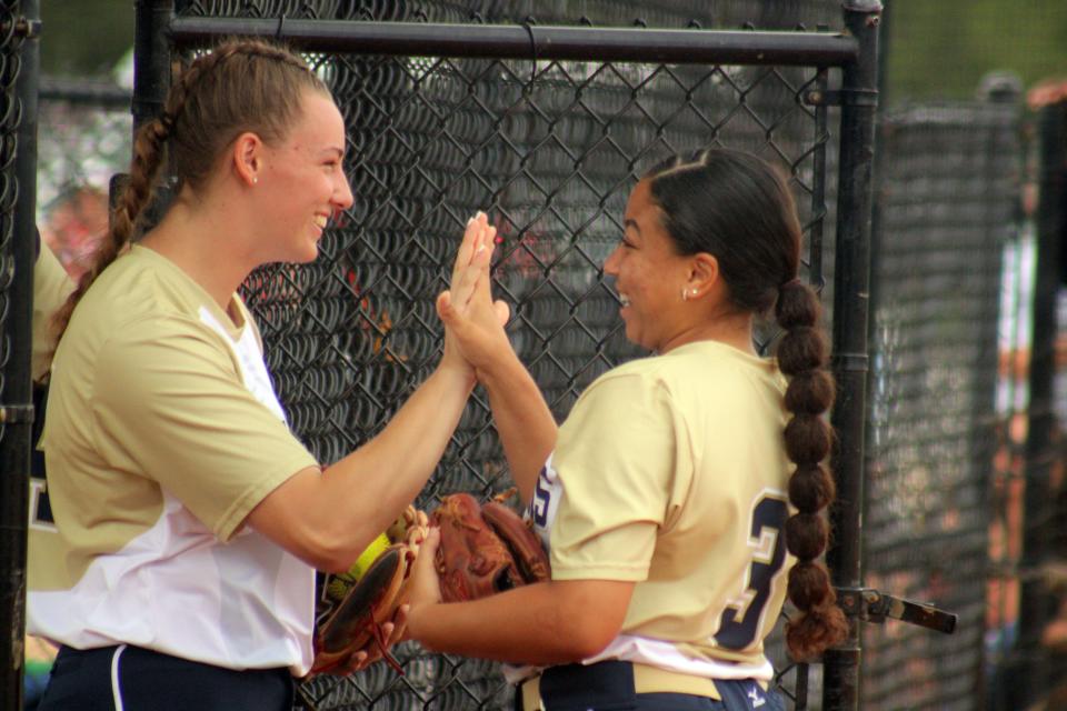 University Christian's Sophia Kardatzke (24) and Jaleigha Harris (3) exchange high fives before the FHSAA Class 2A final.