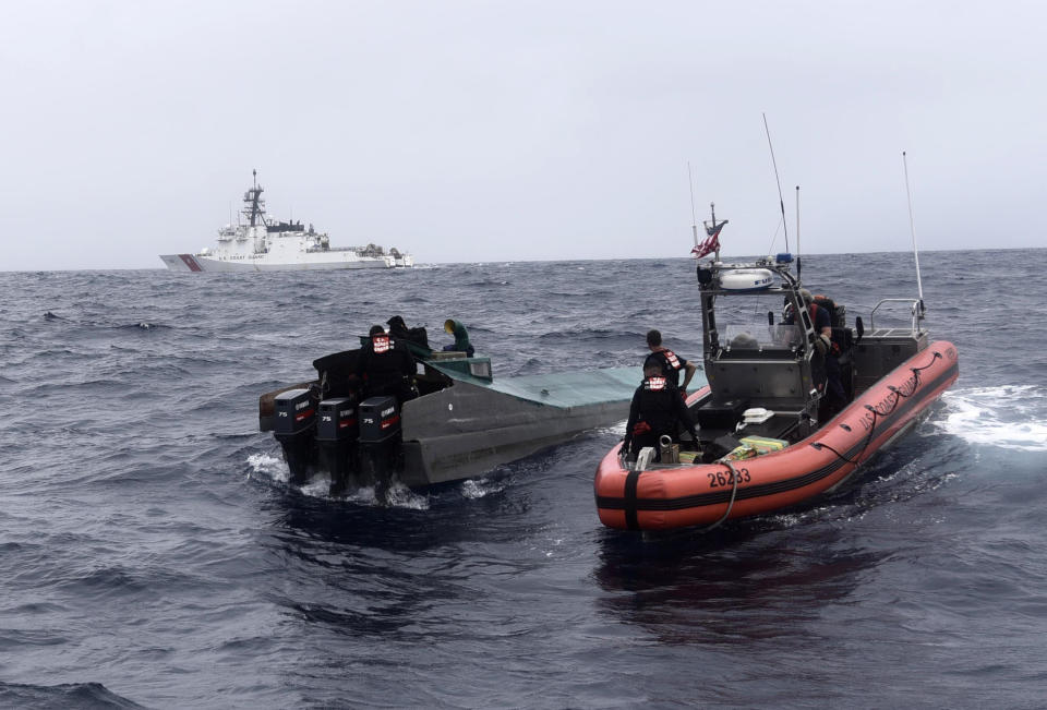 In this Nov. 4, 2019 photo provided by the U.S. Coast Guard, Coast Guard Cutter Bertholf (WMSL 750) boarding teams interdict a low-profile go-fast vessel while patrolling international waters of the Eastern Pacific Ocean, seizing more than 3,100 pounds of suspected cocaine. An estimated $312 million worth of cocaine seized from smugglers in the eastern Pacific Ocean has been brought to San Diego. About 18,000 pounds (8,165 kilograms) of the drug was offloaded Wednesday, Dec. 18, 2019, from the Coast Guard cutter Bertholf. (Petty Officer 2nd Class Paul Krug/U.S. Coast Guard via AP)