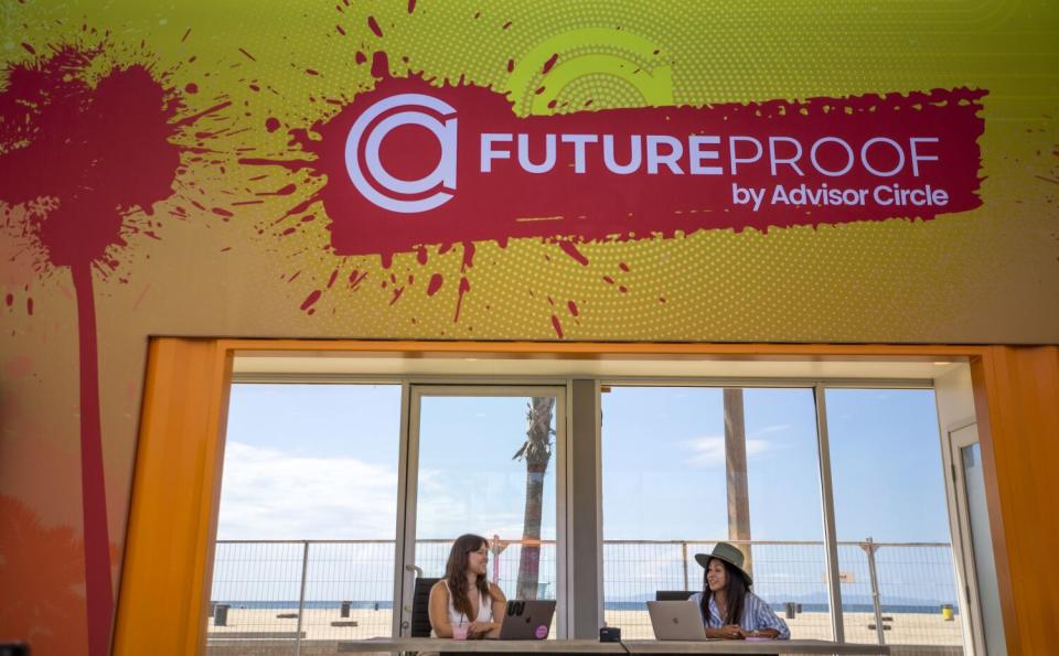 Two women sit under a Future Proof logo.