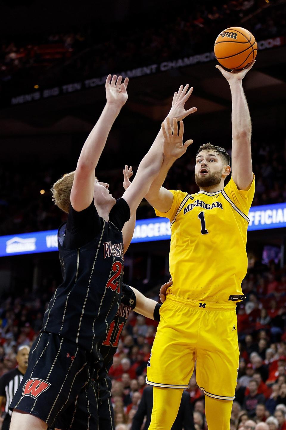 Michigan center Hunter Dickinson scores over Wisconsin's Steven Crowl during the first half on Tuesday, Feb. 14, 2023, in Madison, Wisconsin.