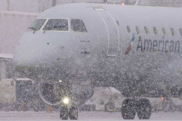 <p>David Ryder/Bloomberg via Getty Images</p> An American Eagle plane taxis during a snow storm at Seattle-Tacoma International Airport (SEA) in Seattle, Washington, US, on Tuesday, Dec. 20, 2022