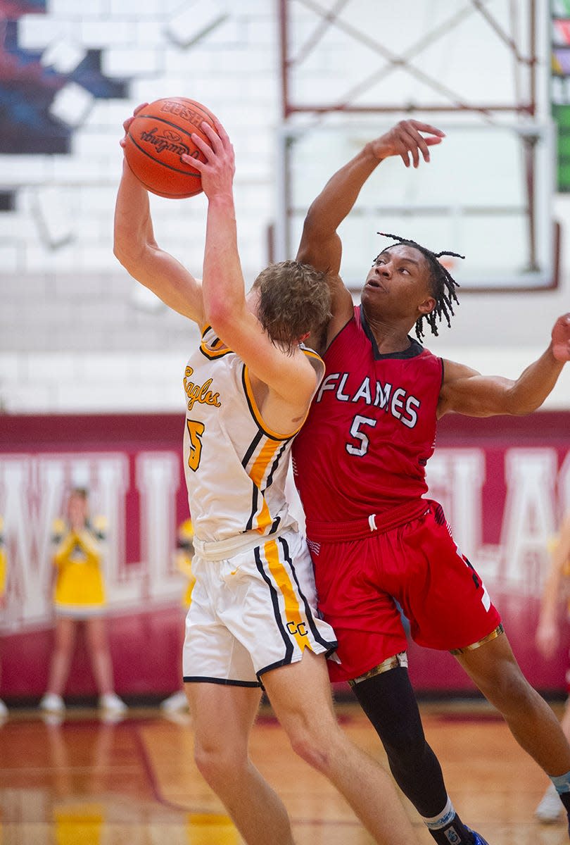 Colonel Crawford's Trevor Vogt is fouled by Mansfield Christian's Amarr Davis on an inbound.