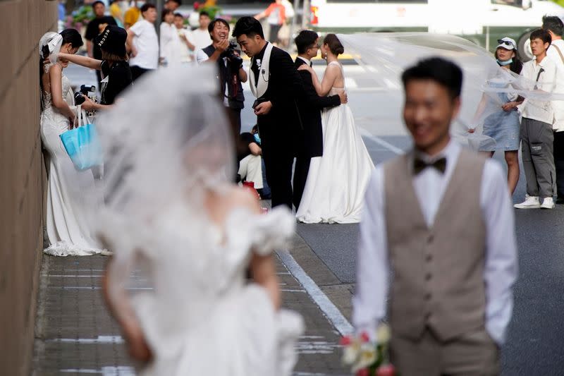 FILE PHOTO: Couples prepare to get their photo taken during a wedding photography shoot, amid the coronavirus disease pandemic, in Shanghai