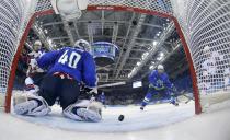 Team USA's Phil Kessel (R) scores his third goal of the game on Slovenia's goalie Luka Gracnar as USA's James van Riemsdyk (L) and Slovenia's Mitja Robar look on during second period of their men's preliminary round ice hockey game at the 2014 Sochi Winter Olympics, February 16, 2014. REUTERS/Matt Slocum/Pool (RUSSIA - Tags: OLYMPICS SPORT ICE HOCKEY)