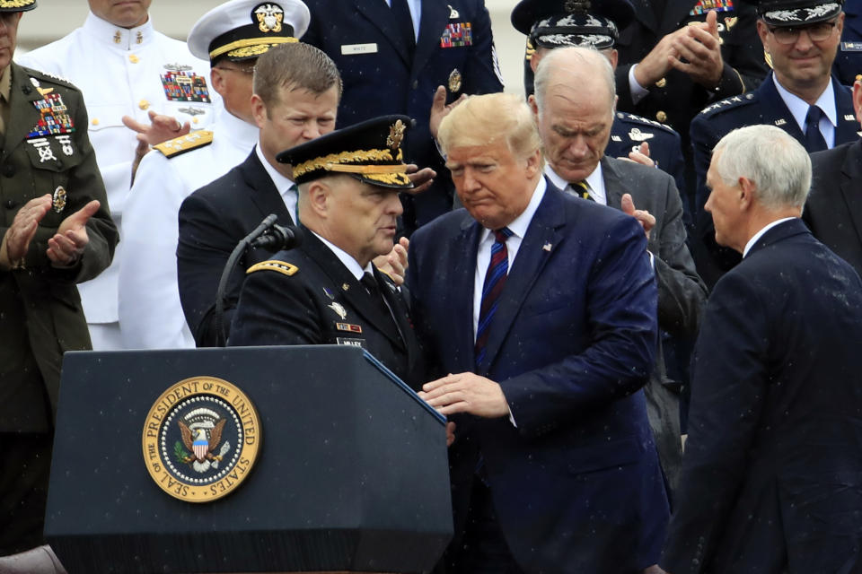 President Donald Trump participates in an Armed Forces welcome ceremony for the new chairman of the Joint Chiefs of Staff, Gen. Mark Milley, left, Monday, Sept. 30, 2019, at Joint Base Myer-Henderson Hall, Va. (AP Photo/Manuel Ceneta)