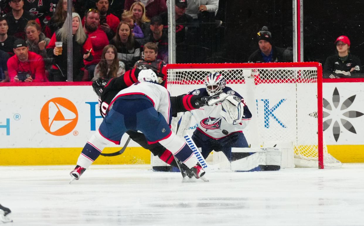 Apr 7, 2024; Raleigh, North Carolina, USA; Columbus Blue Jackets goalie Malcolm Subban (32) stops the scoring attempt by Carolina Hurricanes center Jack Drury (18) during the second period at PNC Arena. Mandatory Credit: James Guillory-USA TODAY Sports