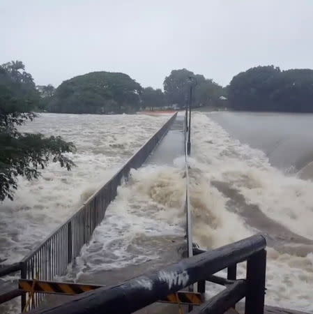 Floodwater flows over the Aplins Weir Rotary Park footbridge in Mundingburra district, Townsville, Queensland, Australia Feburary 3, 2019 in this still taken from social media video. Nathan Hughes via REUTERS