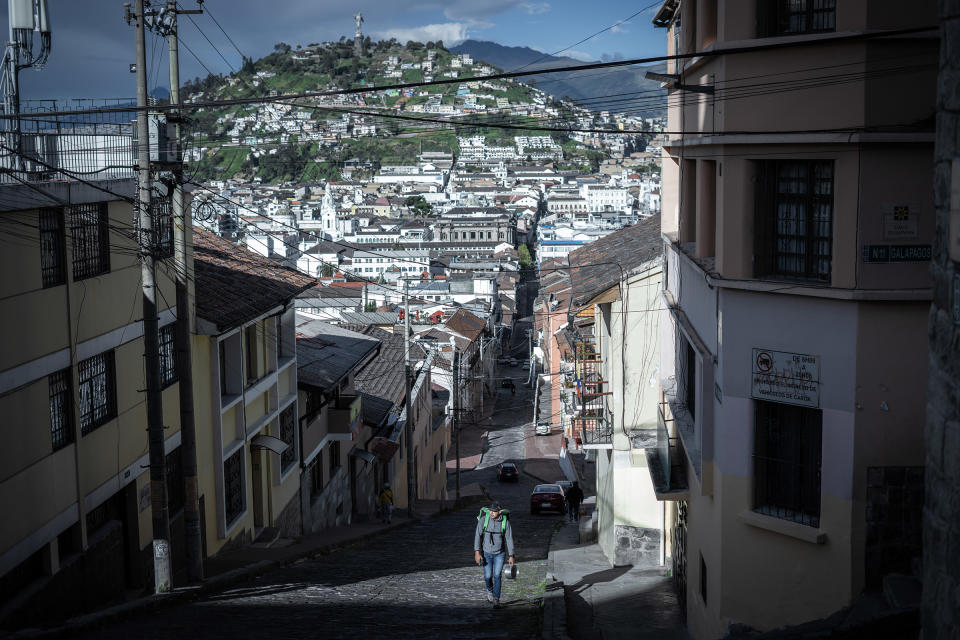 A delivery man walks to a garage he rents in the center of Quito, Ecuador. Many delivery drivers do not own their motorcycles or garages and often rent, leaving them with less profit.<span class="copyright">Isadora Romero—Magnum Foundation</span>