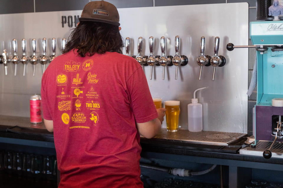 A bar employee pours a beer at Pondaseta Brewing Company in Amarillo.