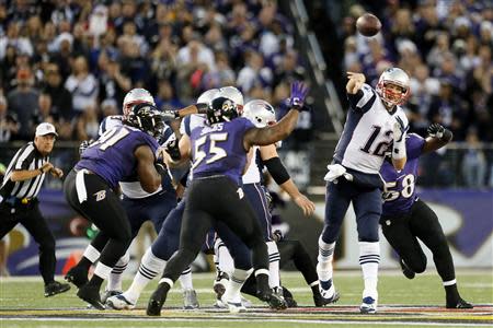 Dec 22, 2013; Baltimore, MD, USA; New England Patriots quarterback Tom Brady (12) passes e against the Baltimore Ravens at M&T Bank Stadium. Mandatory Credit: Mitch Stringer-USA TODAY Sports