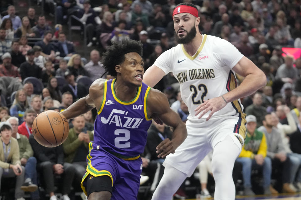 Utah Jazz guard Collin Sexton (2) drives around New Orleans Pelicans forward Larry Nance Jr. (22) during the first half of an NBA basketball game, Monday, Nov. 27, 2023, in Salt Lake City. (AP Photo/Rick Bowmer)