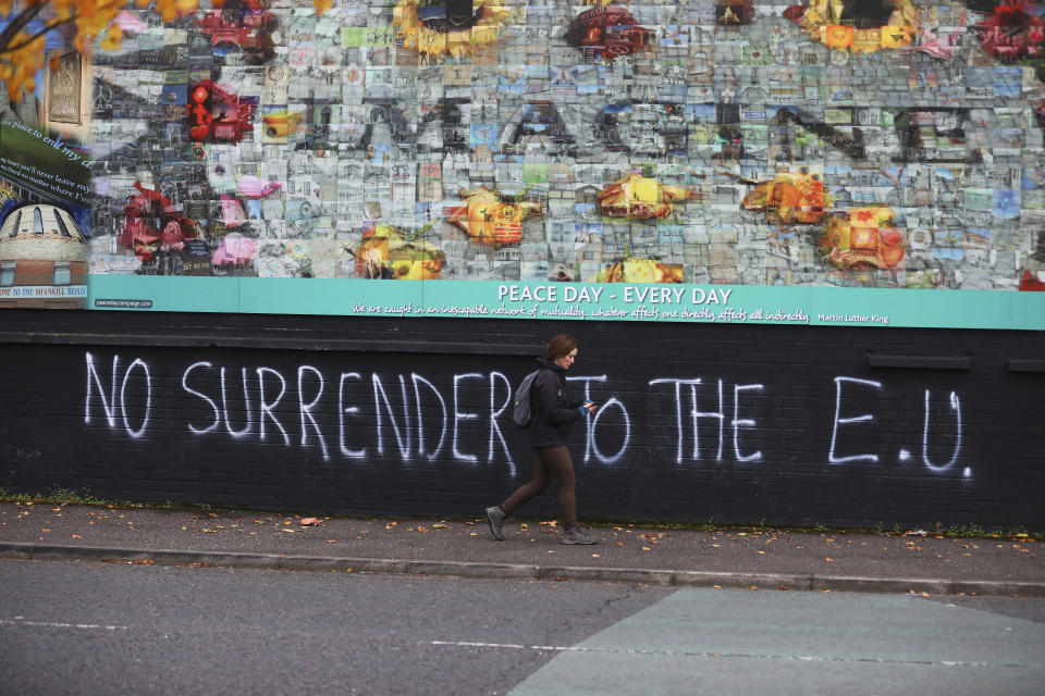 Pro Brexit graffiti on a wall that separates a Protestant area from a Catholic area of West Belfast, Northern Ireland, Tuesday, Oct. 15, 2019. Brexit continues to be a contentious debate around The UK and Northern Ireland. (AP Photo/Peter Morrison)