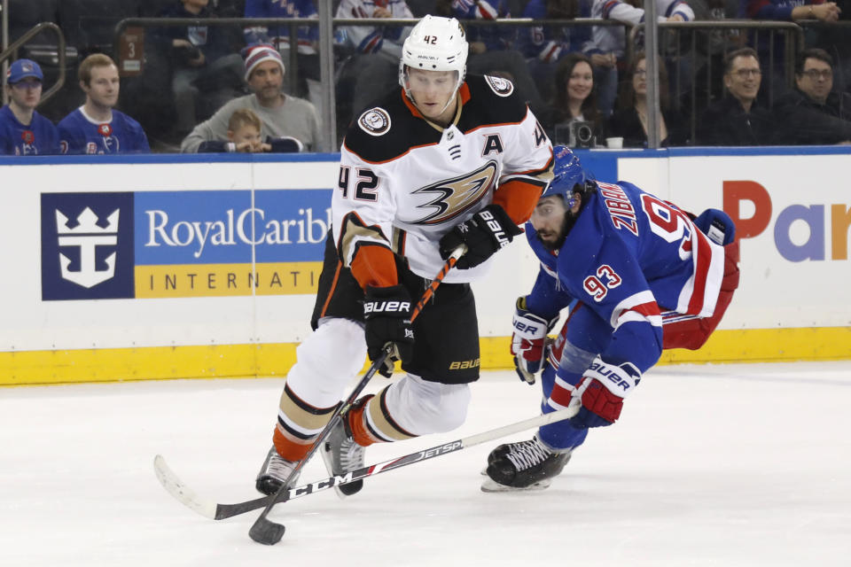 Anaheim Ducks defenseman Josh Manson (42) controls the puck in front of New York Rangers center Mika Zibanejad (93) during the second period of an NHL hockey game, Sunday, Dec. 22, 2019, in New York. (AP Photo/Kathy Willens)