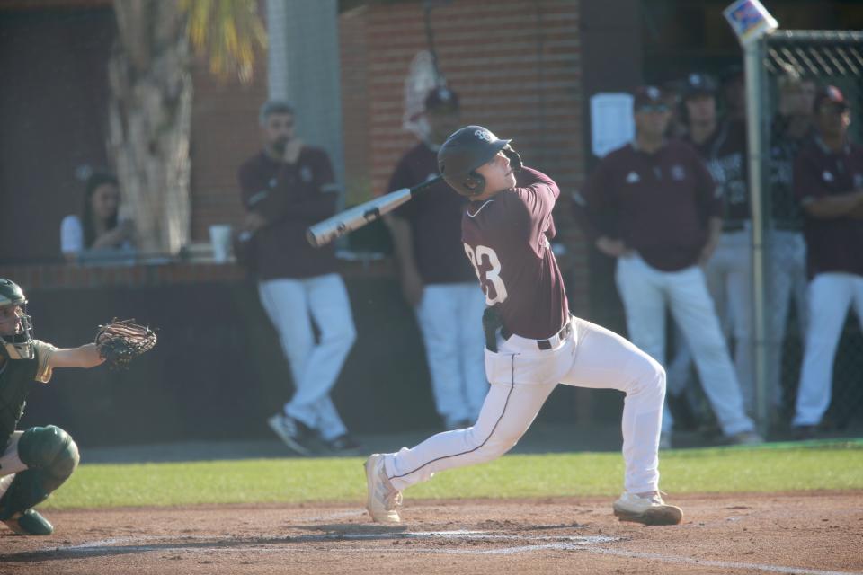 Benedictine's Parker McCoy follows through on his swing during a 2022 home game.