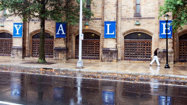 PHOTO: A person walks by a Yale sign on the Yale University campus, Aug. 22, 2021, in New Haven, Conn. (Ted Shaffrey/AP Photo)