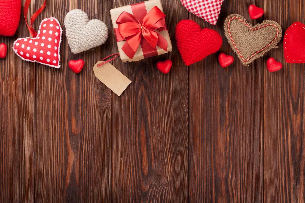 Valentines day background with handmaded hearts and candies over wood. Top view with copy space