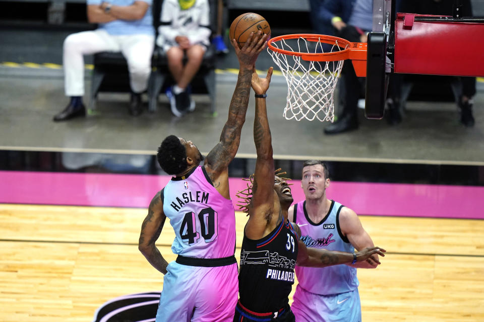 Miami Heat forward Udonis Haslem (40) vies for a rebound against Philadelphia 76ers center Dwight Howard (39) during the first half of an NBA basketball game Thursday, May 13, 2021, in Miami. (AP Photo/Lynne Sladky)