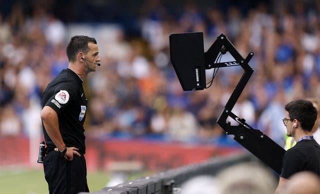 Referee Andrew Madley consults the pitchside monitor during the West Ham v Chelsea match before disallowing a goal by Maxwel Cornet 