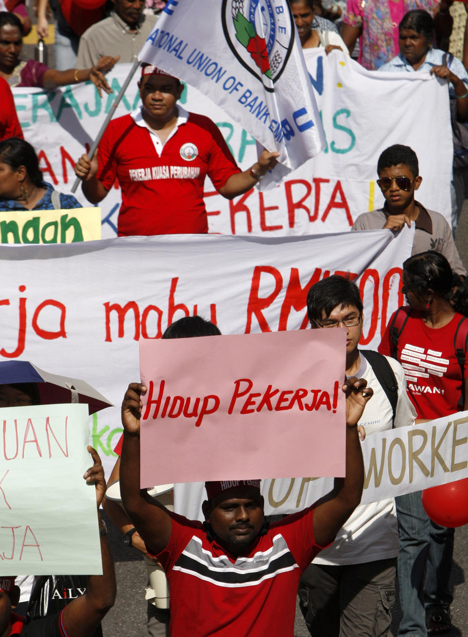 A worker holds a placard reading "Long Live Workers" during a May Day rally to call for a minimum wage law in Kuala Lumpur, Malaysia, Tuesday, May 1, 2012. (AP Photo/Lai Seng Sin)