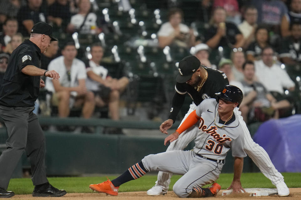 Chicago White Sox third baseman Yoan Moncada, top right, tags out Detroit Tigers' Kerry Carpenter (30) during the eighth inning of a baseball game Saturday, Sept. 2, 2023, in Chicago. (AP Photo/Erin Hooley)