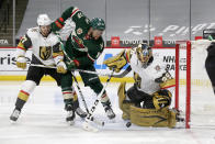 Vegas Golden Knights goaltender Marc-Andre Fleury (29) blocks a shot by Minnesota Wild left wing Jordan Greenway (18) while Golden Knights' Shea Theodore (27) defends during the second period of an NHL hockey game, Wednesday, May 5, 2021, in St. Paul, Minn. (AP Photo/Andy Clayton-King)