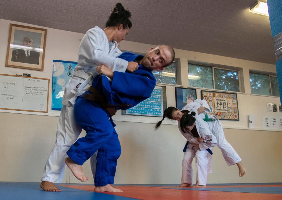 Rob Crumly, right, flips Susan Hok during a practice of the Stockton Judo Club at the McKinley Park Community Center in south Stockton.