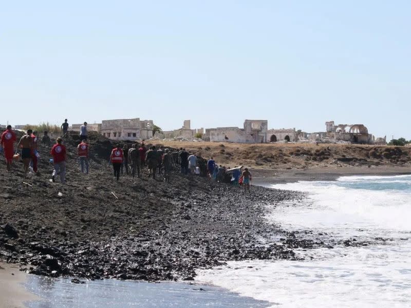 Members of Syrian Red Crescent work by a shoreline in Tartous