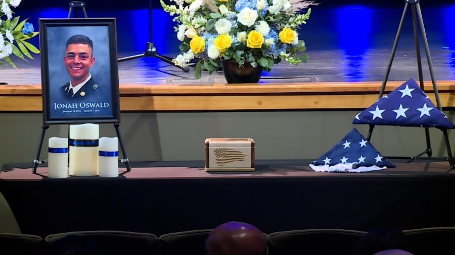 A photo of Fairway Officer Jonah Oswald sits on a table with his ashes and an American flag at the fallen officer's funeral on Aug. 14, 2023.