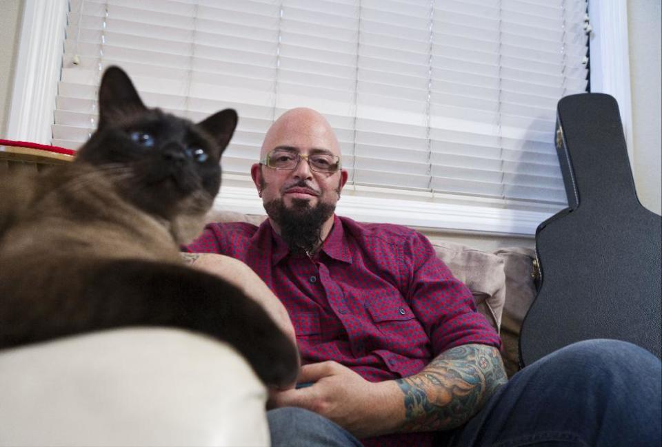 This undated photo provided by the Animal Planet shows cat behaviorist Jackson Galaxy host of the Animal Planet television show "My Cat from Hell" with Lulu in the Sherman Oaks section of Los Angeles. Cats don't turn on their families for no reason, says Galaxy. He's worried about Internet hysteria that 's been building since March 7, 2014, when an Oregon family called 911 to report that Lux the cat had them trapped in a bedroom and they couldn't get out. (AP Photo/Animal Planet, John Chapple)