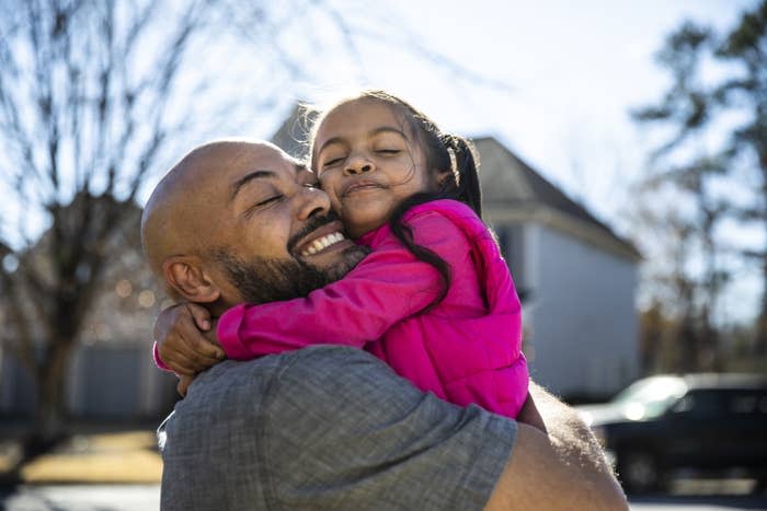 father and young daughter hugging