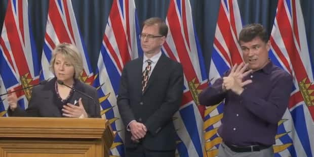 ASL interpreter Nigel Howard, right, is seen at a coronavirus press conference alongside B.C.'s Provincial Medical Health Officer Dr. Bonnie Henry and Adrian Dix, the province's health minister, on March 17, 2020.