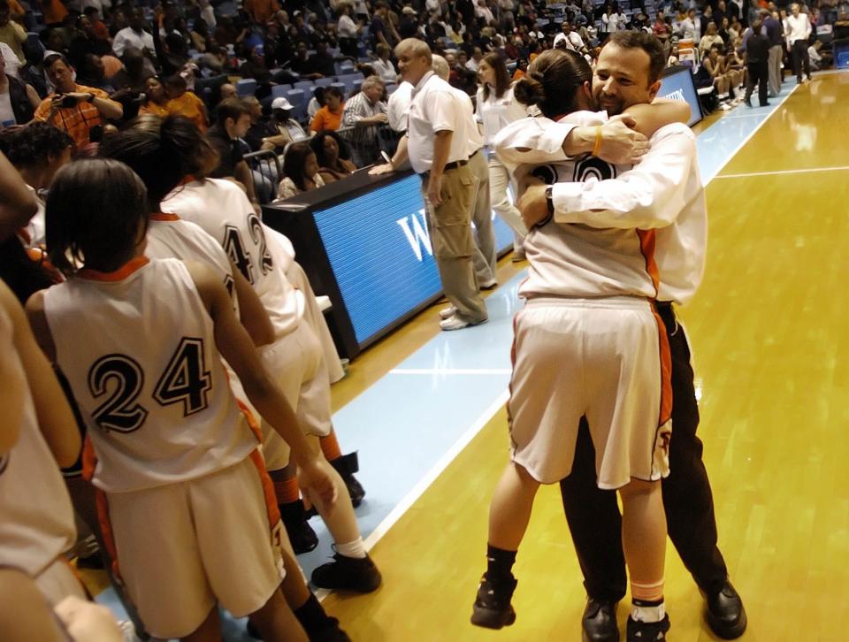 South View's Head Coach Brent Barker hugs palyer Samantha Ramirez after beating Greensboro's Grimsley High School to win the 4-A NCHSAA Championship game at the Dean Smith Center in Chapel Hill, N.C., in 2007. South View beat Grimsley 69-64.