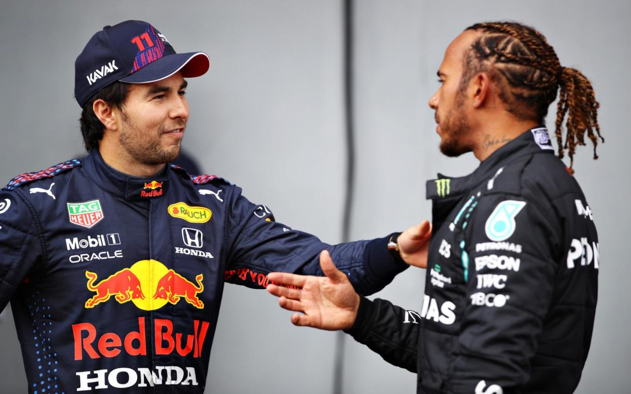 Second place qualifier Sergio Perez of Mexico and Red Bull Racing and pole position qualifier Lewis Hamilton of Great Britain and Mercedes GP talk in parc ferme during qualifying ahead of the F1 Grand Prix of Emilia Romagna at Autodromo Enzo e Dino Ferrari on April 17, 2021 in Imola, Italy - Getty Images Europe /Mark Thompson 