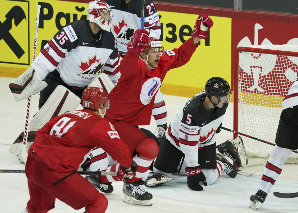 Yevgeni Timkin of Russia, centre, celebrates a goal against Darcy Kuemper of Canada during the Ice Hockey World Championship quarterfinal match between Russia and Canada at the Olympic Sports Center in Riga, Latvia, Thursday, June 3, 2021. (AP Photo/Roman Koksarov)